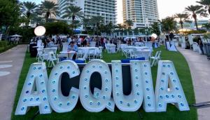 Color photo of outdoor Acquia signage at Engage Miami