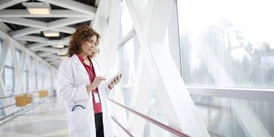 healthcare worker in front of large window 