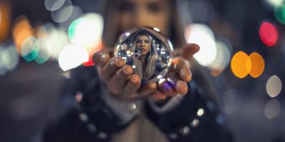 Color photo of woman holding crystal ball