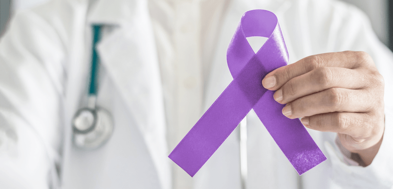 Doctor holding purple ribbon