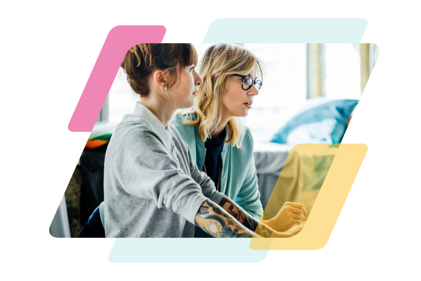 pink, teal, and yellow parallelograms with an image of two people looking at a computer