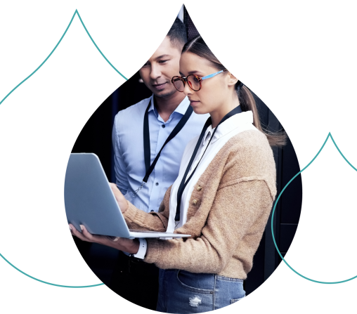 Two people looking over a laptop standing with teal acquia droplets