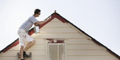 man painting a house