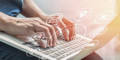 Hands typing on laptop