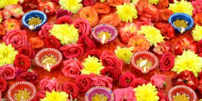 Diwali lights surrounded by yellow, orange and red flowers