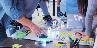 UX designers brainstorming about wireframes with digital projections