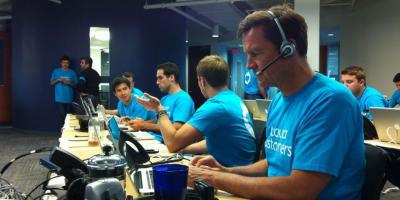 Acquia staff members type at computers in the office.