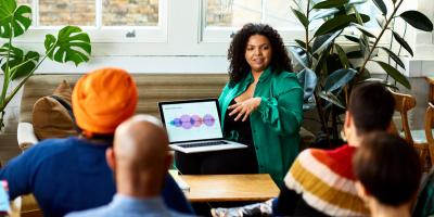 Color photo of woman giving a presentation from her laptop