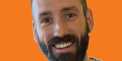Paul Maddison Headshot on Orange Background