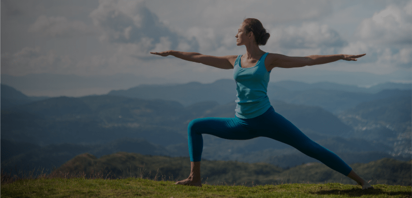 Woman doing yoga pose outdoors