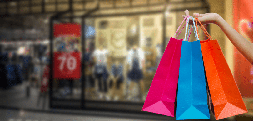 Person holding colorful shopping bags