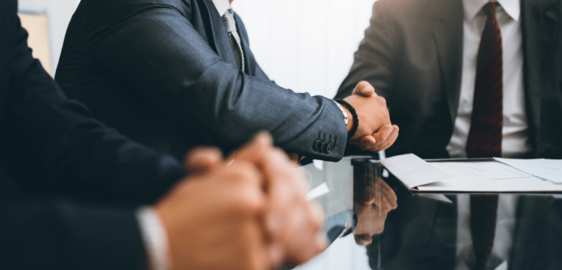 Business men in suits shaking hands