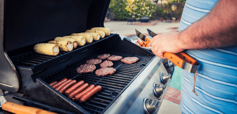 Man grilling meat and vegetables on the grill