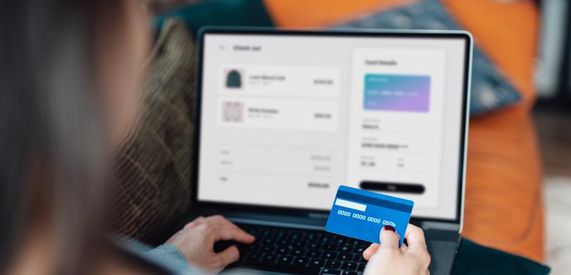 Over-the-shoulder view of someone entering credit card information online