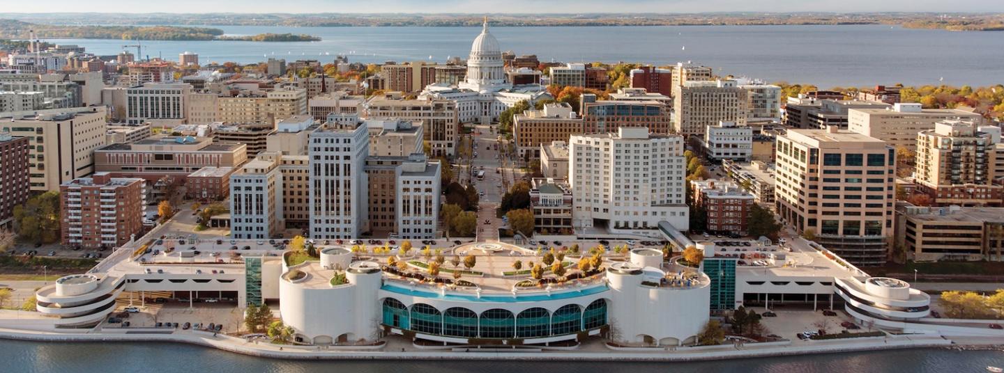 Downtown waterfront cityscape with modern buildings and marina at golden hour