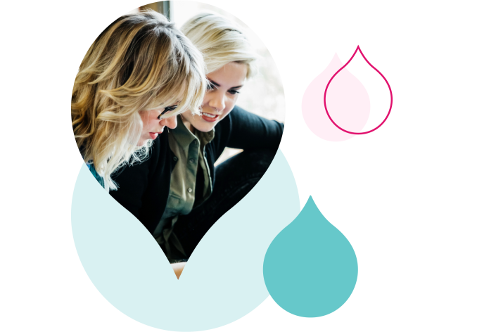 pink and teal acquia droplets cropping an image of two women looking over a computer