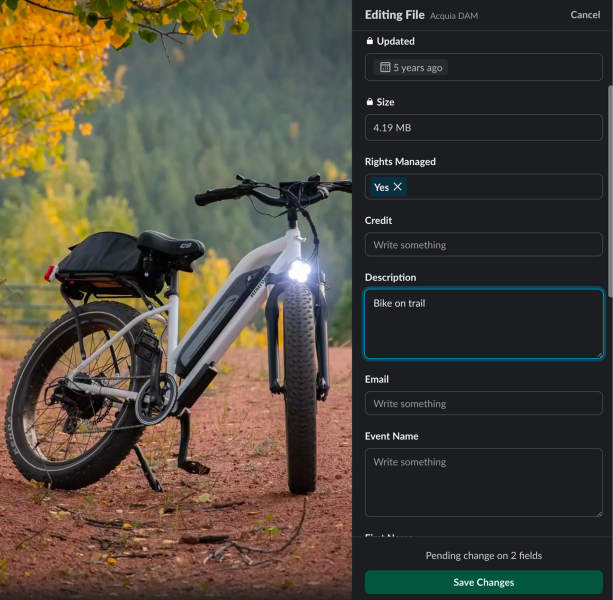 Black mountain bike parked on autumn trail with yellow foliage and editing interface visible.