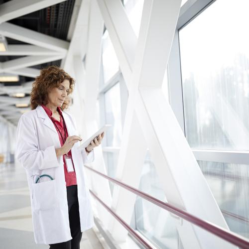 healthcare worker in front of large window 