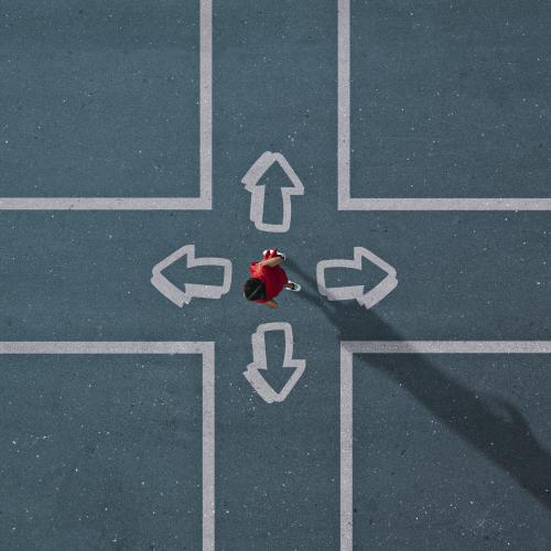 Overhead view of person at a crossroad choosing between four directions