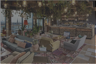 Modern hotel lobby with colorful sofas, chandeliers, and floor-to-ceiling windows