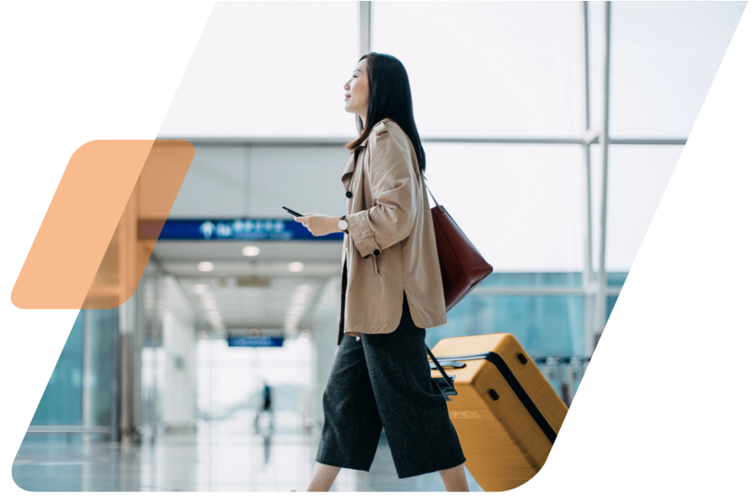 image of a person walking through an airport with an orange suitcase masked by a parallelogram