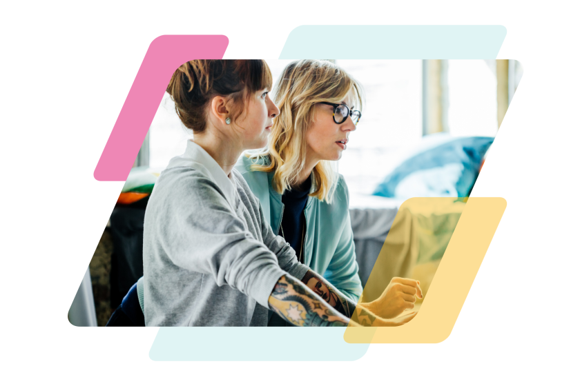 pink, teal, and yellow parallelograms with an image of two people looking at a computer