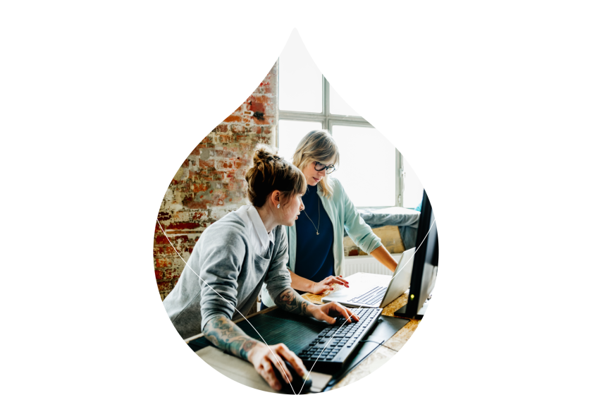 acqui droplet masking an image of two women in an office leaning over a desk