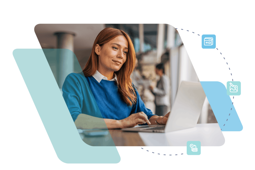 Woman in blue top working on laptop at desk