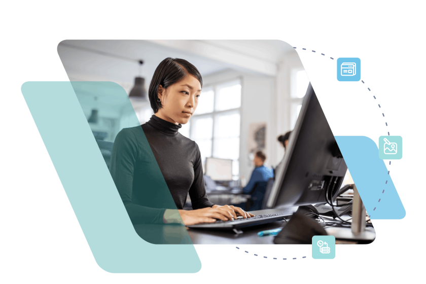 Woman working at computer desk with dual monitors in modern office setting