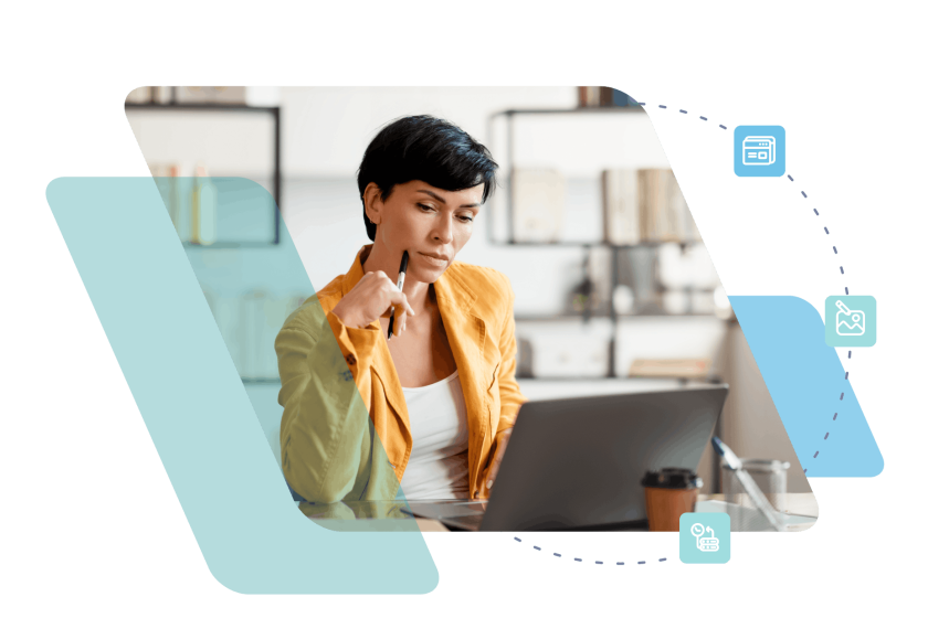 Woman with short dark hair thoughtfully touching her chin while working on laptop in modern kitchen