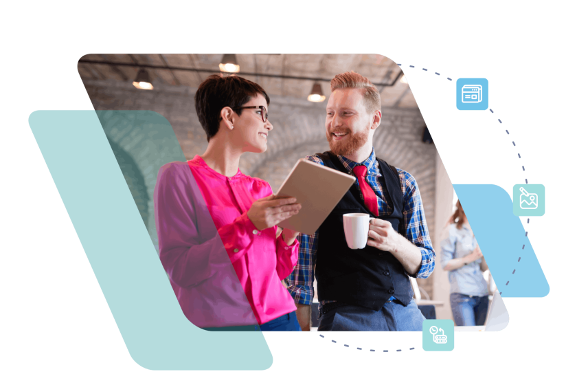 Two people collaborating at work, one in pink shirt pointing at tablet held by colleague in suit