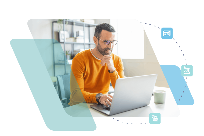 Man in orange shirt working on laptop at modern office desk
