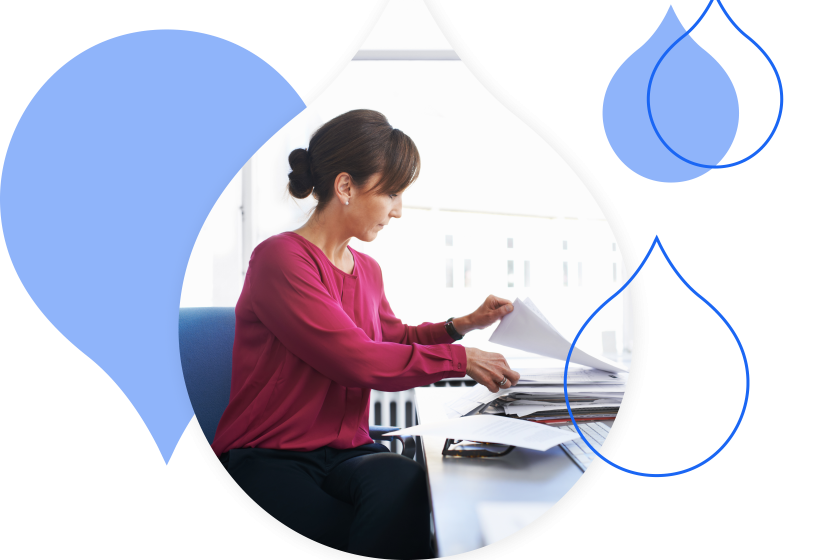 blue acquia droplets cropping an image of a person looking through paper work