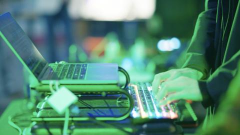 image of a close up of hands on a laptop at a Drupal event