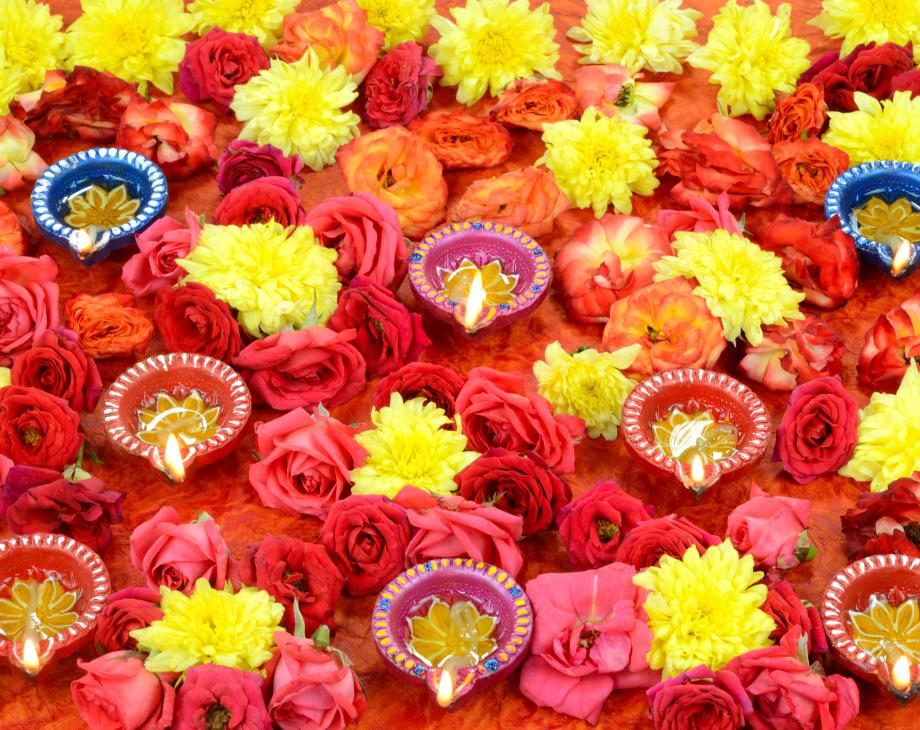 Diwali lights surrounded by yellow, orange and red flowers