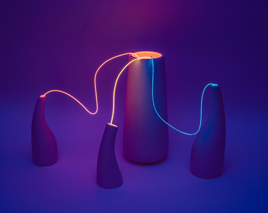 Color image of 3 vase-like forms connected by string or wire to a cylinder 