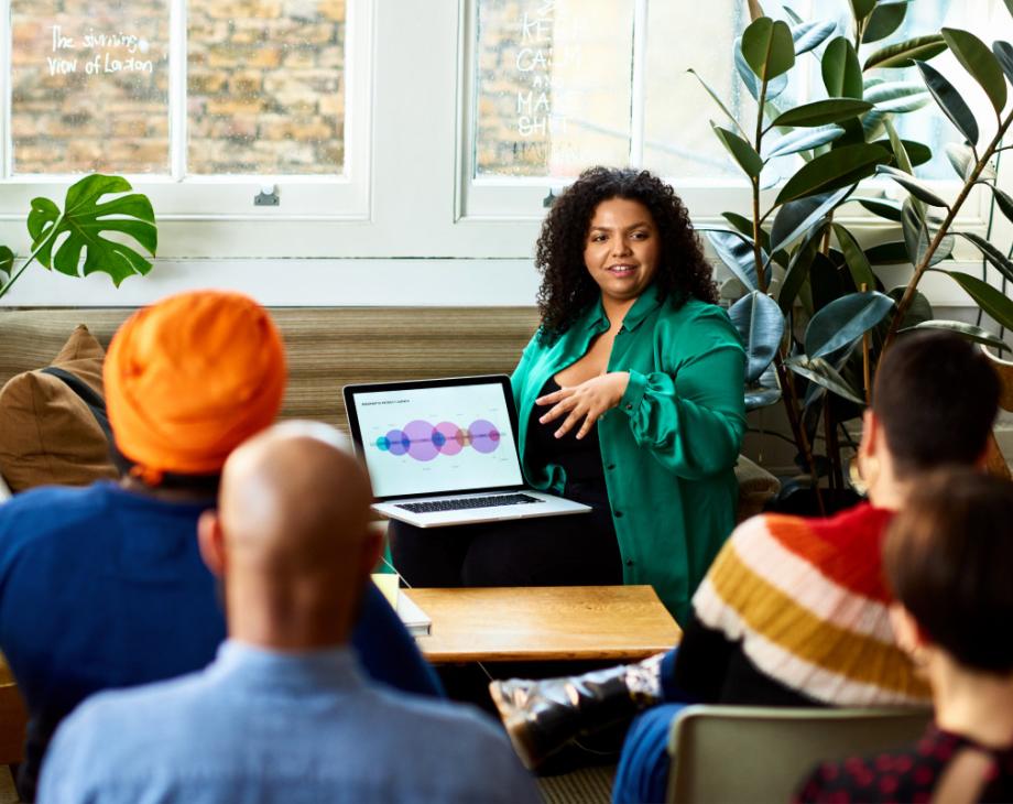 Color photo of woman giving a presentation from her laptop