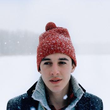 picture of Tim wearing a red beanie in the snow