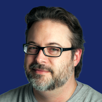 Corey Chimko Headshot on Dark Blue Background