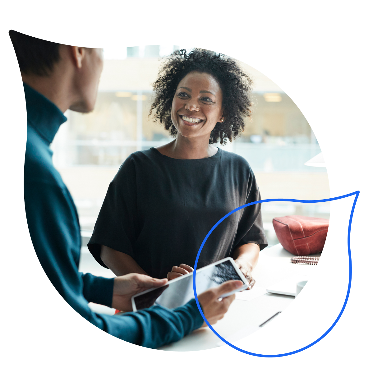 two people speaking while one holds a tablet masked by the acquia droplet