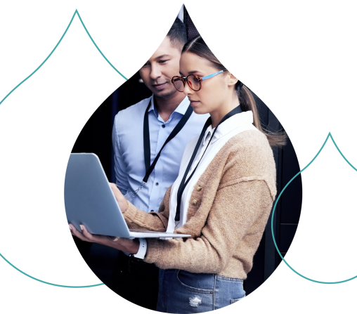 Two people looking over a laptop standing with teal acquia droplets