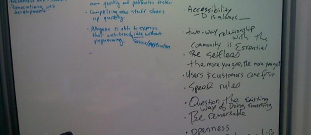 Color photo of white board with written notes about Acquia's values