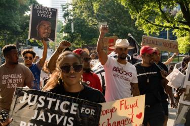 Color photo of marchers in Atlanta on the one-year anniversary of George Floyd's death